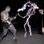 A man plays guitar as high voltage of up to 1 million volts, generated by a Tesla coil transformer, runs through his body during a stunt performance in Changle, Fujian Province of China.. (Photo by Liu Tao/ChinaFotoPress)