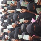 Yemen women receive Oxfam identity cards that entitle them to cash grants which will help families to buy food. Importing 90 per cent of its wheat, Yemen is particularly vulnerable to price shocks and 267,000 children there face death from malnutrition this year alone. Image: Caroline Gluck/Oxfam