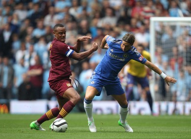 Vincent Kompany tangles with Fernando Torres.