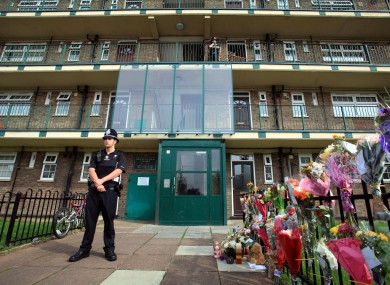 A police officer stands outside a block of flats, in Mitcham, south London, where Natalie Sharp, the mother of Tia Sharp, lives
