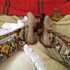 Aztec print? Check. Obscure brand of beer? Check. Her own feet? check.