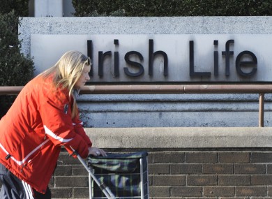 A woman passes the Irish Life headquarters in Dublin. The group has recorded profits of €116 million for the first half of 2012.