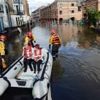 Fire Brigade crews from York take care staff to a residential home in Skeldergate by boat as floodwater continues to cover many city centre streets in York. Image: John Giles/PA Wire.