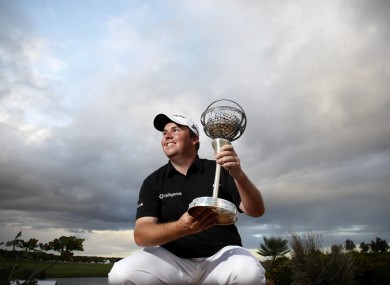 Lowry holds his trophy today.