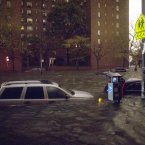 Vehicles are submerged on 14th Street near the Consolidated Edison power plant on Monday in New York. Sandy continued on its path yesterday, as the storm forced the shutdown of mass transit, schools and financial markets, sending coastal residents fleeing, and threatening a dangerous mix of high winds and soaking rain. (AP Photo/ John Minchillo)