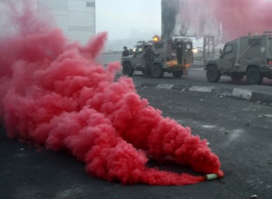 A smoke grenade is thrown by Israeli security forces during a protest against the Israeli military operations in Gaza Strip near the West Bank town of Nablus