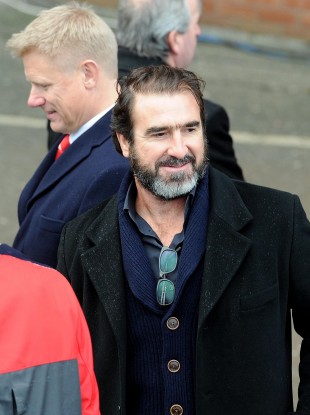 Eric Cantona and, behind, Peter Schmeichel at the ceremony.