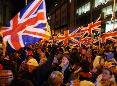 Loyalist protestors carrying Union flags block the back of the City Hall in Belfast