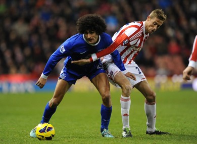 Stoke City's Peter Crouch (right) and Everton's Marouane Fellaini battle for the ball in todays' match.