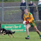 Neil Gallagher of Donegal keeps his focus while in possession despite the nearby distraction.