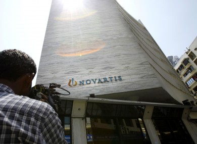 A cameraman films the head office of Novartis India Limited in Mumbai, India