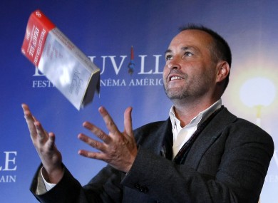 Colum McCann poses with his book 'Let the Great World Spin' after winning the Literary Award at the 35th American Film Festival in Normandy, France, in 2009.