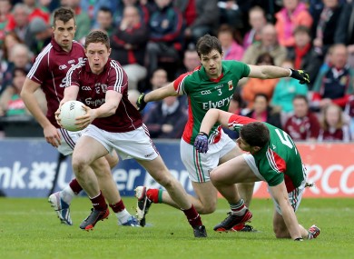 Mayo's Ger Cafferkey and Lee Keegan with Conor Doherty of Galway.