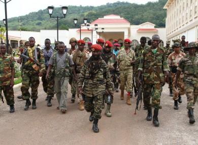 In this March 27, 2013 photo, rebel soldiers from the Seleka alliance walk in front of the Ledger Plaza Bangui hotel, in Bangui, Central African Republic.