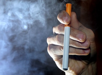 A person smokes an electronic cigarette, or e-cigarette.