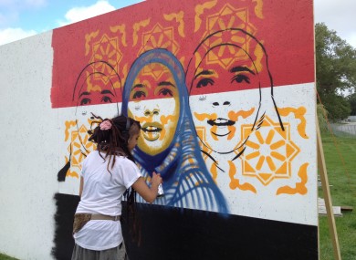 Mexican artist Kathrina Rupit works on the mural earlier this week.