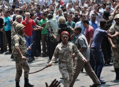 Egyptian security forces try to keep angry crowds away from the al-Fatah mosque