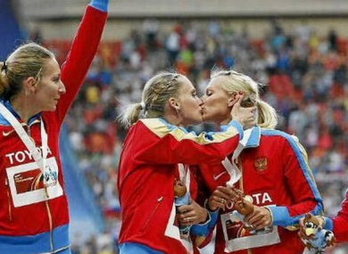 Ksenia Ryzhova and Yulia Gushchina embrace on the podium.