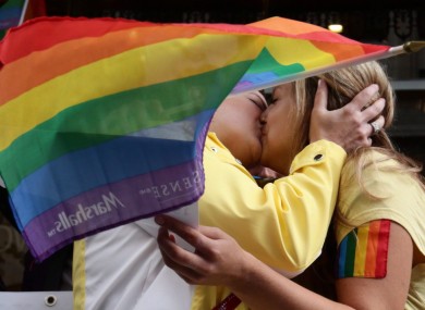 People taking part in a kiss-in protest outside the Russian Consulate in Vancouver
