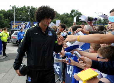 Everton's Marouane Fellaini signs autographs for fans in the Players' Parade outside Goodison Park.
