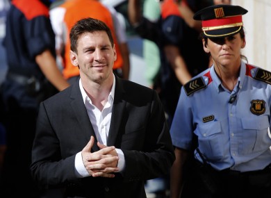 Barcelona star Lionel Messi, left, arrives at a court to answer questions in a tax fraud case.