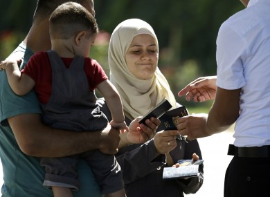Syrian refugees have their passports checked at the Turkish Cilvegozu border gate.