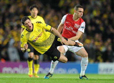 Robert Lewandowski is sent flying from a challenge by Arsenal's Thomas Vermaelen when the sides last met in 2011.
